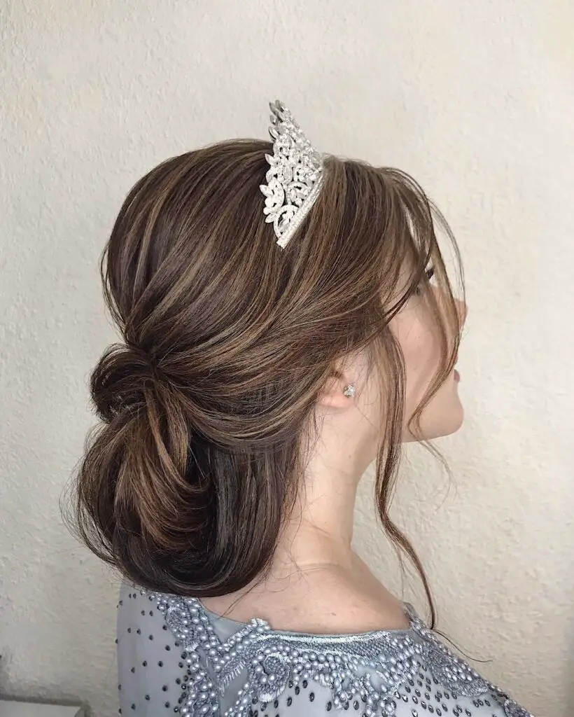 Side view of  a lady wearing her hairdo with curls  with tiara