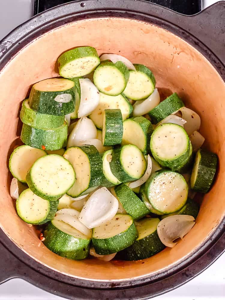 seasoned zucchini slices, onion, and garlic in a large pot.