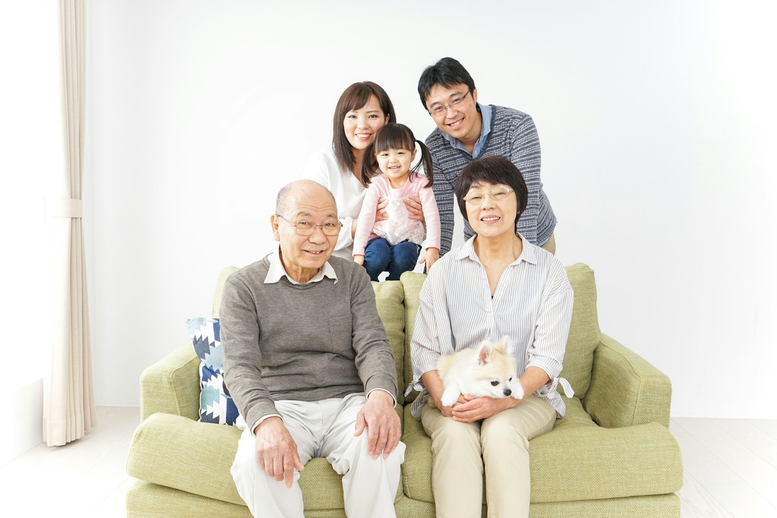 Chinese grandparents sitting in front of their younger family