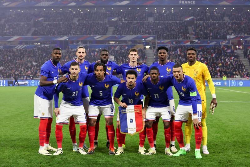 A group of football players posing for a photoDescription automatically generated