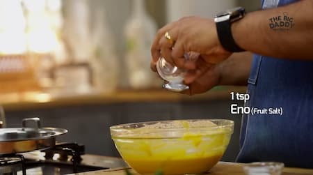 Adding Eno fruit salt to the Dhokla batter to make it frothy.
