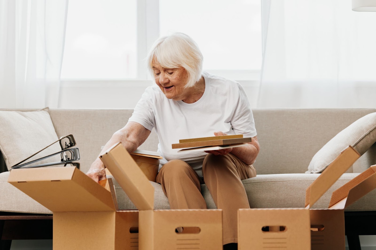 A senior woman organizing her things after her move into a new assisted living community.