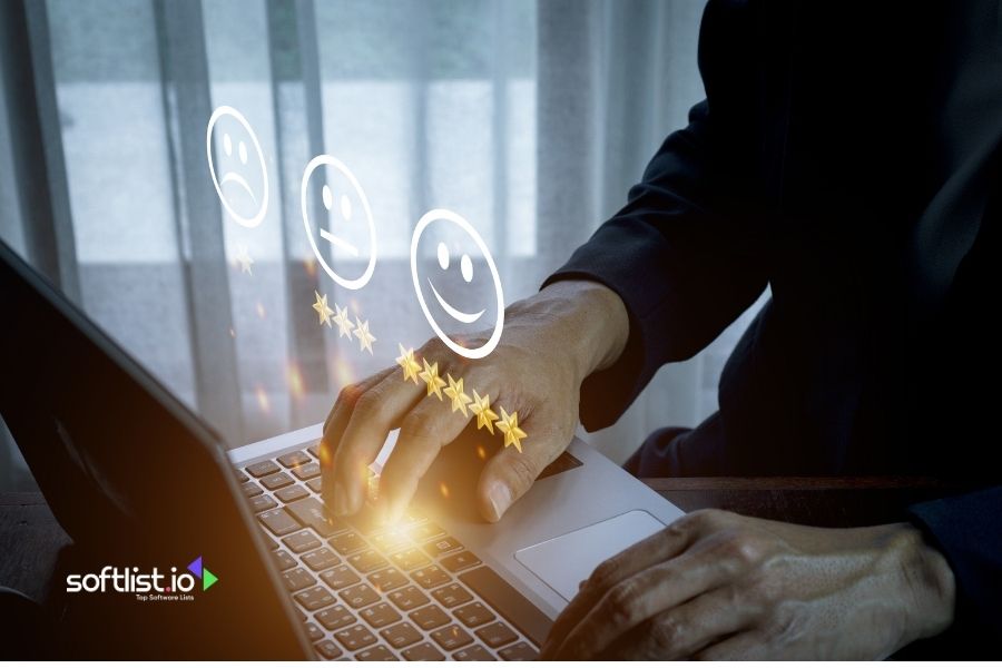 Hand typing on a laptop with star ratings and smiley faces.