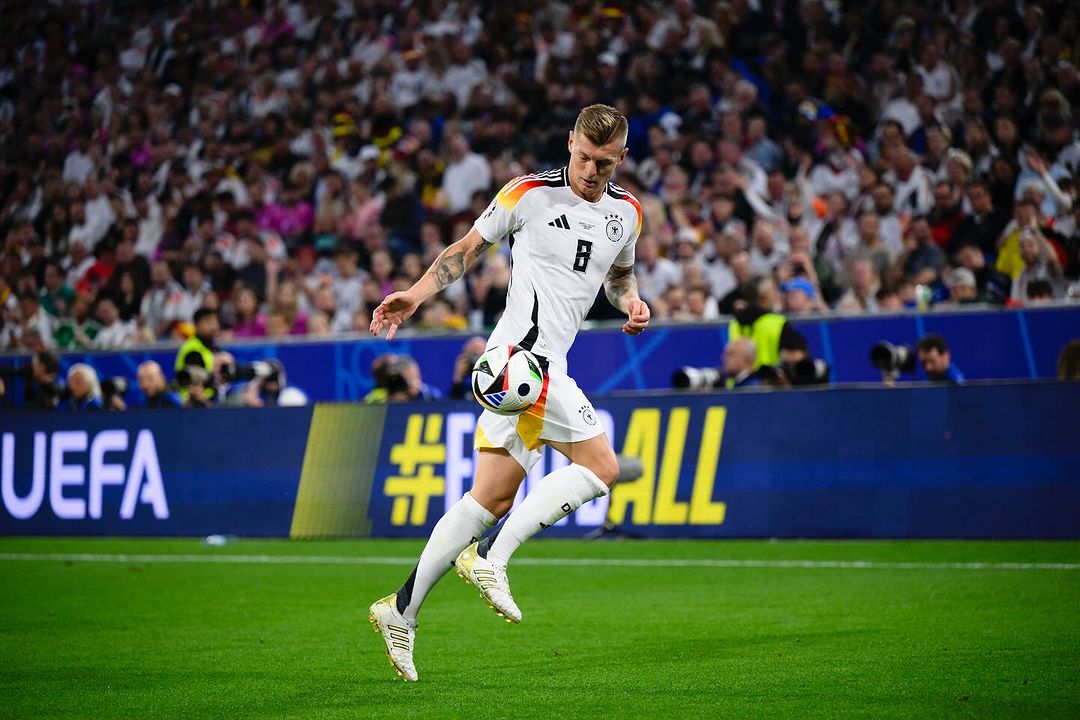 Photo by Toni Kroos on June 15, 2024. May be an image of 1 person, playing football, playing soccer, ball, stadium and text.