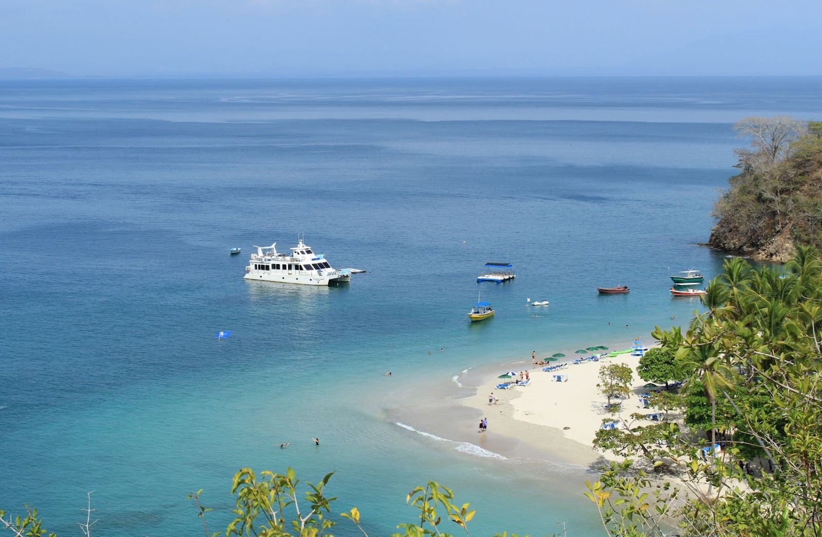 white yacht in the ocean in one of the best beaches in Costa Rica