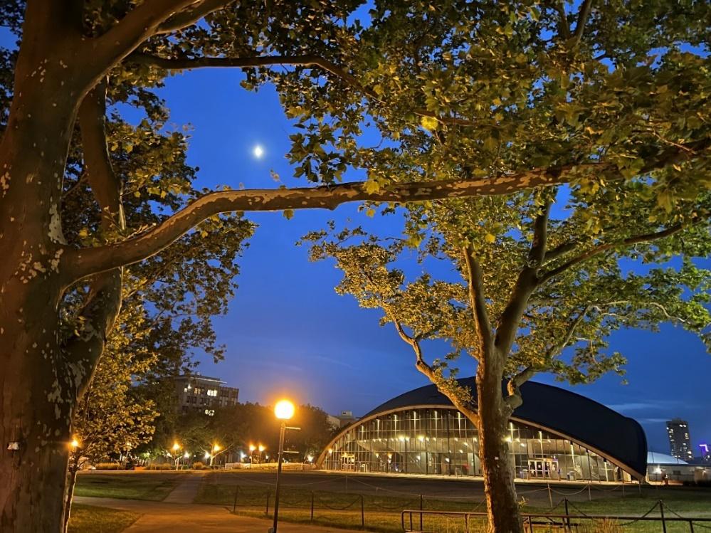 M.I.T.'s Kresge building reflects the sidewalk lights after dusk.