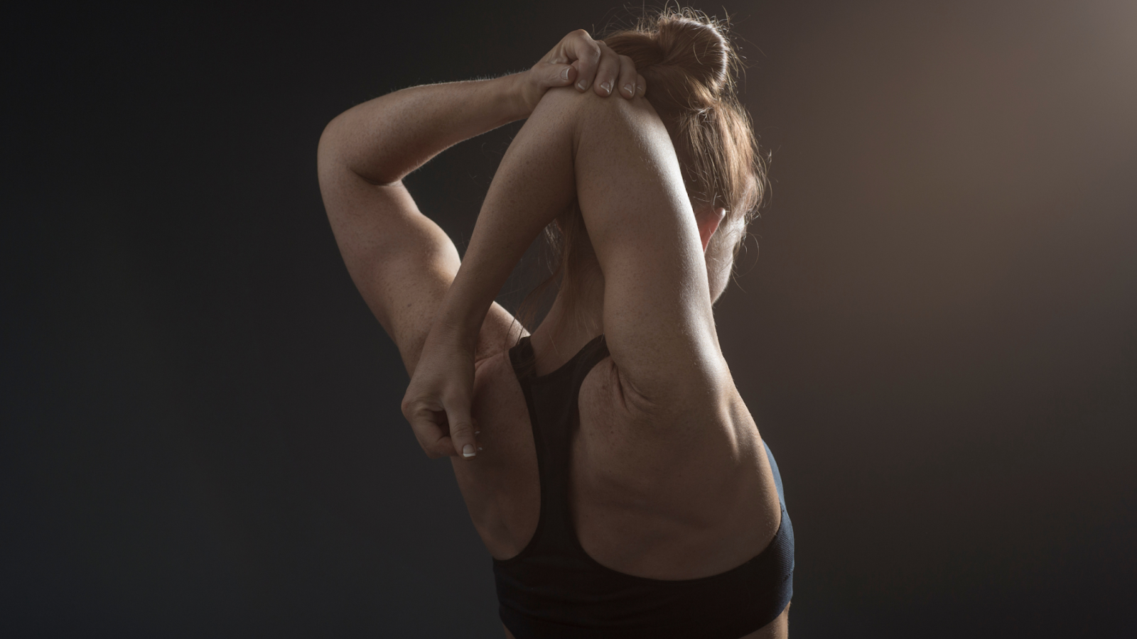 a woman doing static back stretches