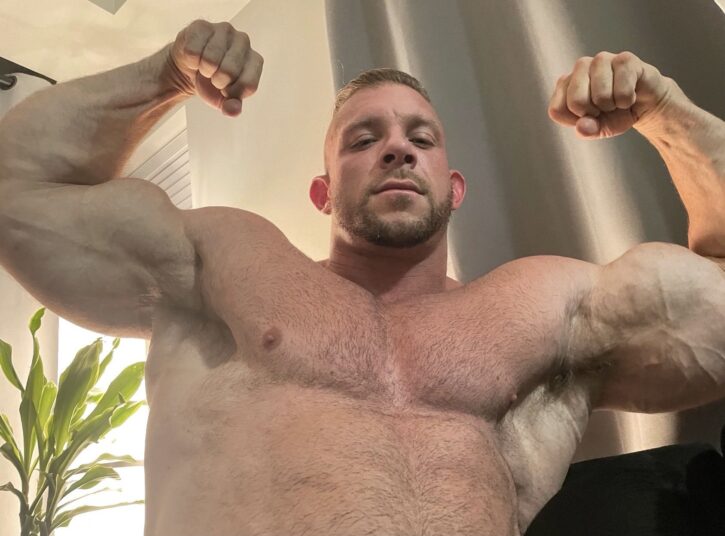 Cody Mac gay xxx onlyfans content creator shirtless flexing his biceps for gay online content