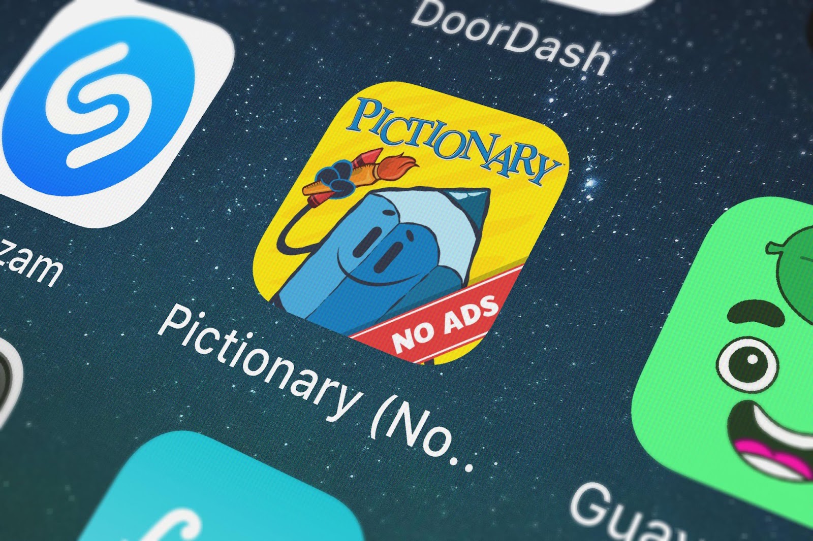 A close-up of the Pictionary app. The icon features a cartoon pencil character holding a paintbrush against a yellow background, making it perfect for team-building activity.