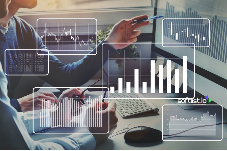 Image of charts and graphs being analyzed by two people on computers.