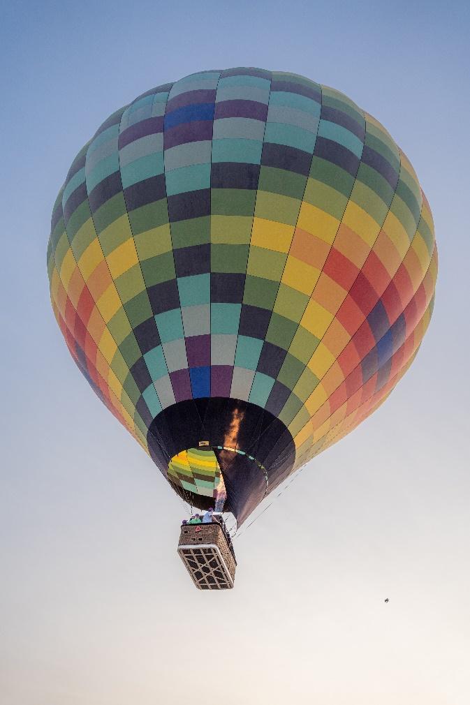 A colorful hot air balloon in the sky

Description automatically generated