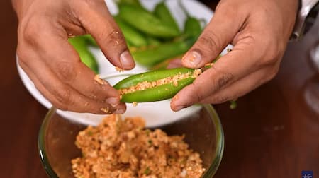 Green chilies being stuffed with paneer-potato filling.