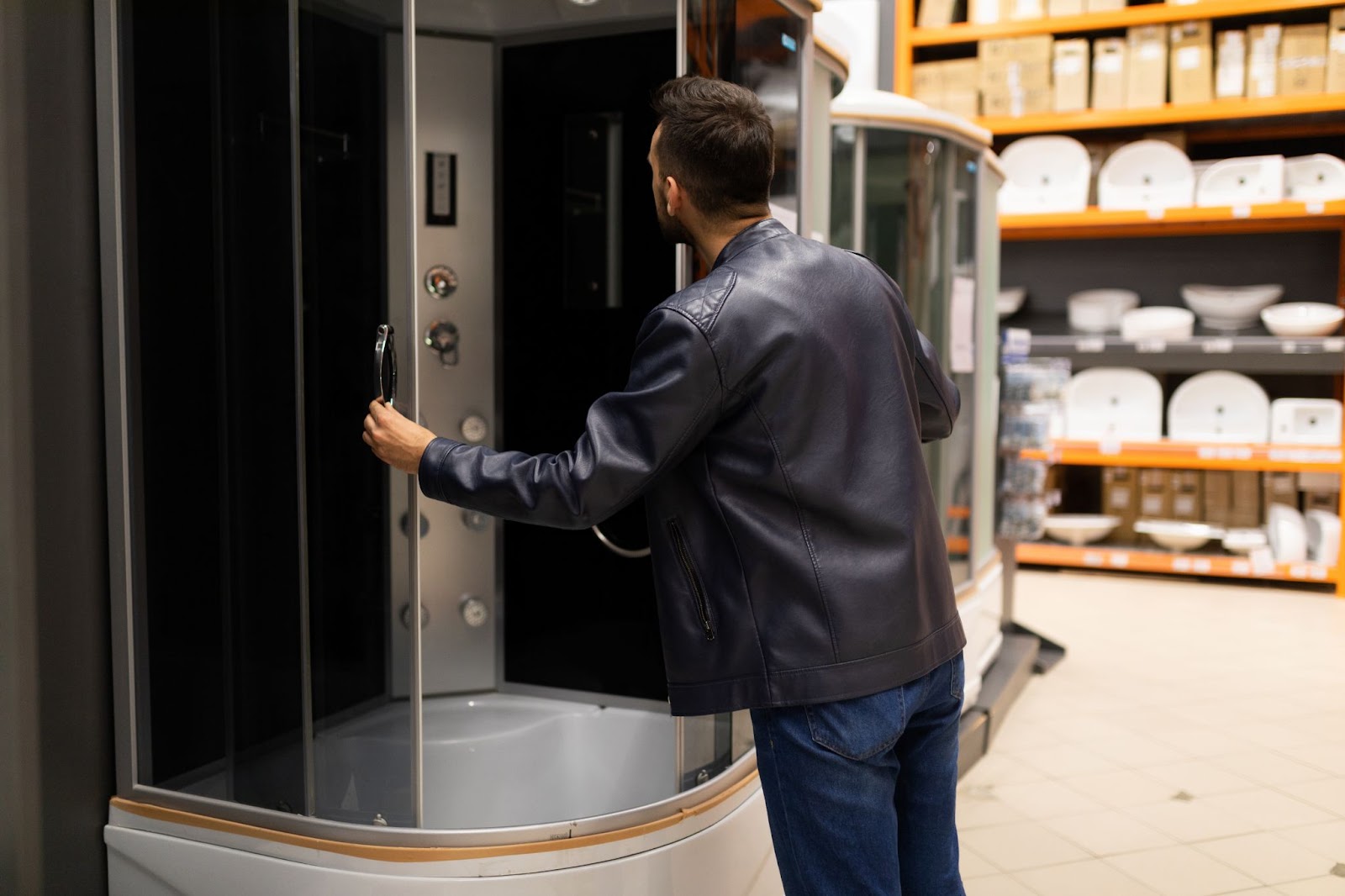  A male buyer is assessing a shower cubicle.