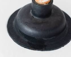Image of plunger positioned over drain
