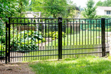 comparing common fencing materials aluminum fence gate in front yard custom built michigan