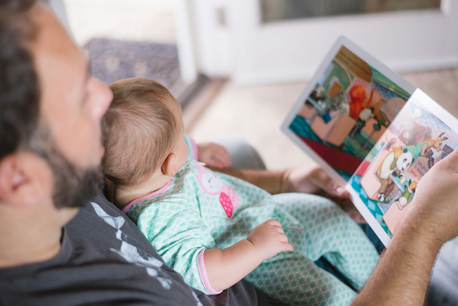 A father with an infant involved in a playful interaction.