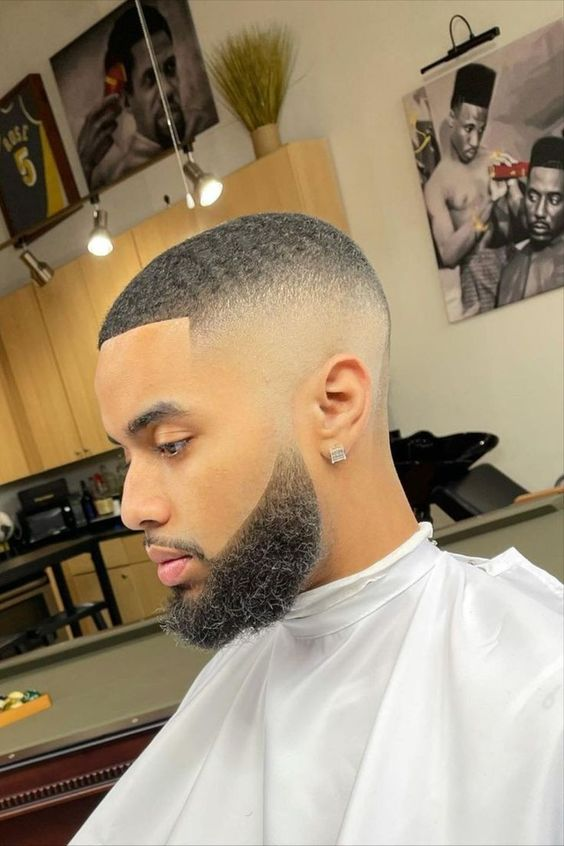 Picture of a man rocking the skin fade and waves