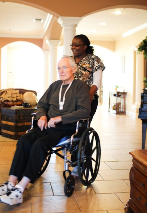 staff helping person in wheelchair