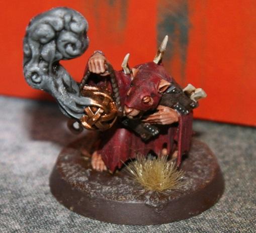 A small figurine of a creature holding a ball Description automatically generated