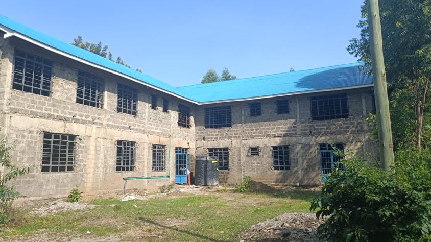 A building with a blue roof Description automatically generated with medium confidence