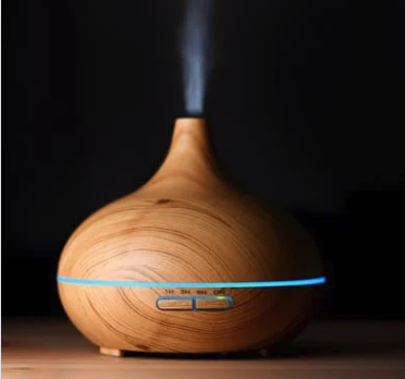 A wooden essential oils diffuser diffusing oil