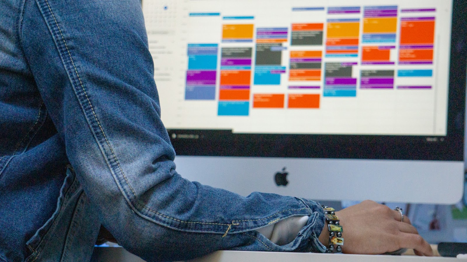 A woman organizing events with a color coded calendar