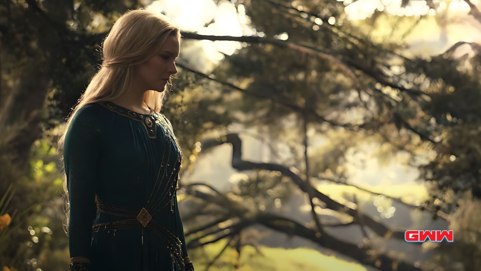 Galadriel in a green dress standing thoughtfully in a sunlit forest.