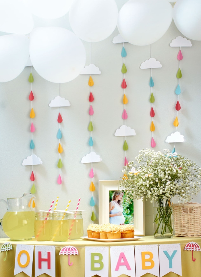 oh baby baby shower table with white balloons and colorful raindrops