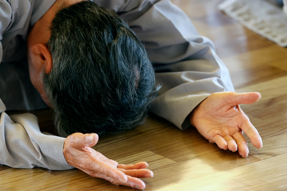 A man conducting prostration, as a form of a spiritual wellness activity