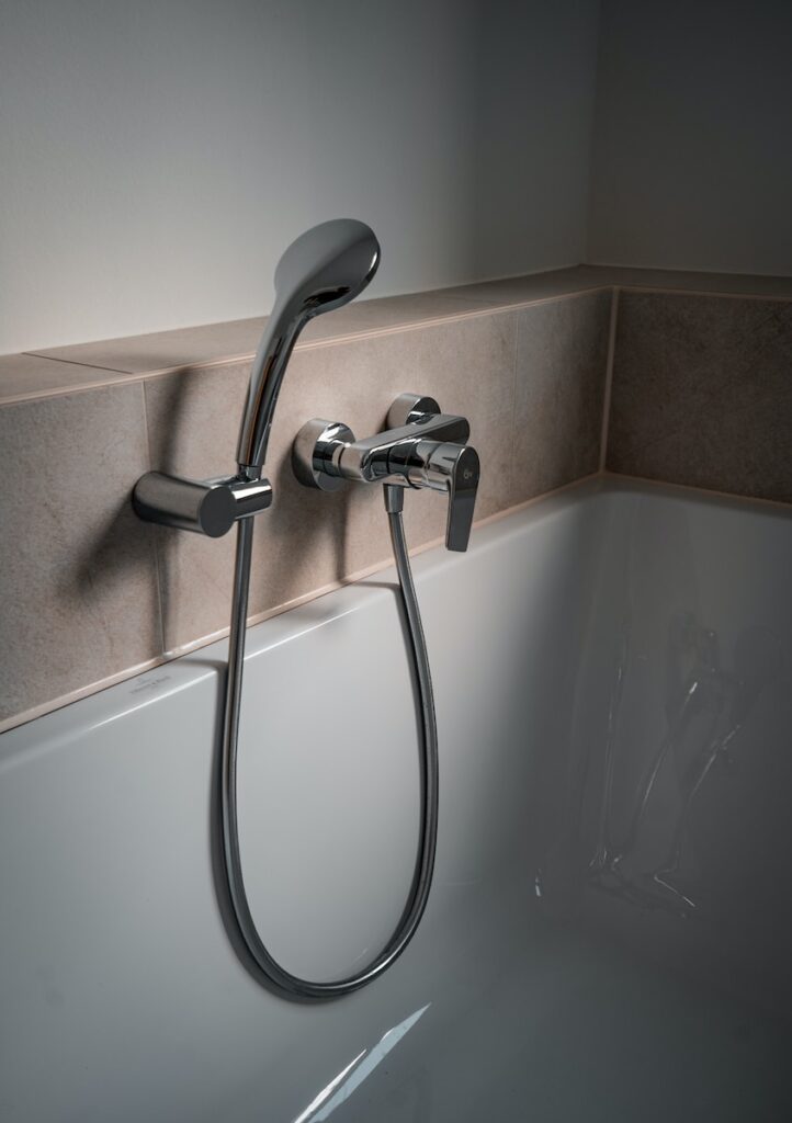 a close up of a bathtub with a shower head