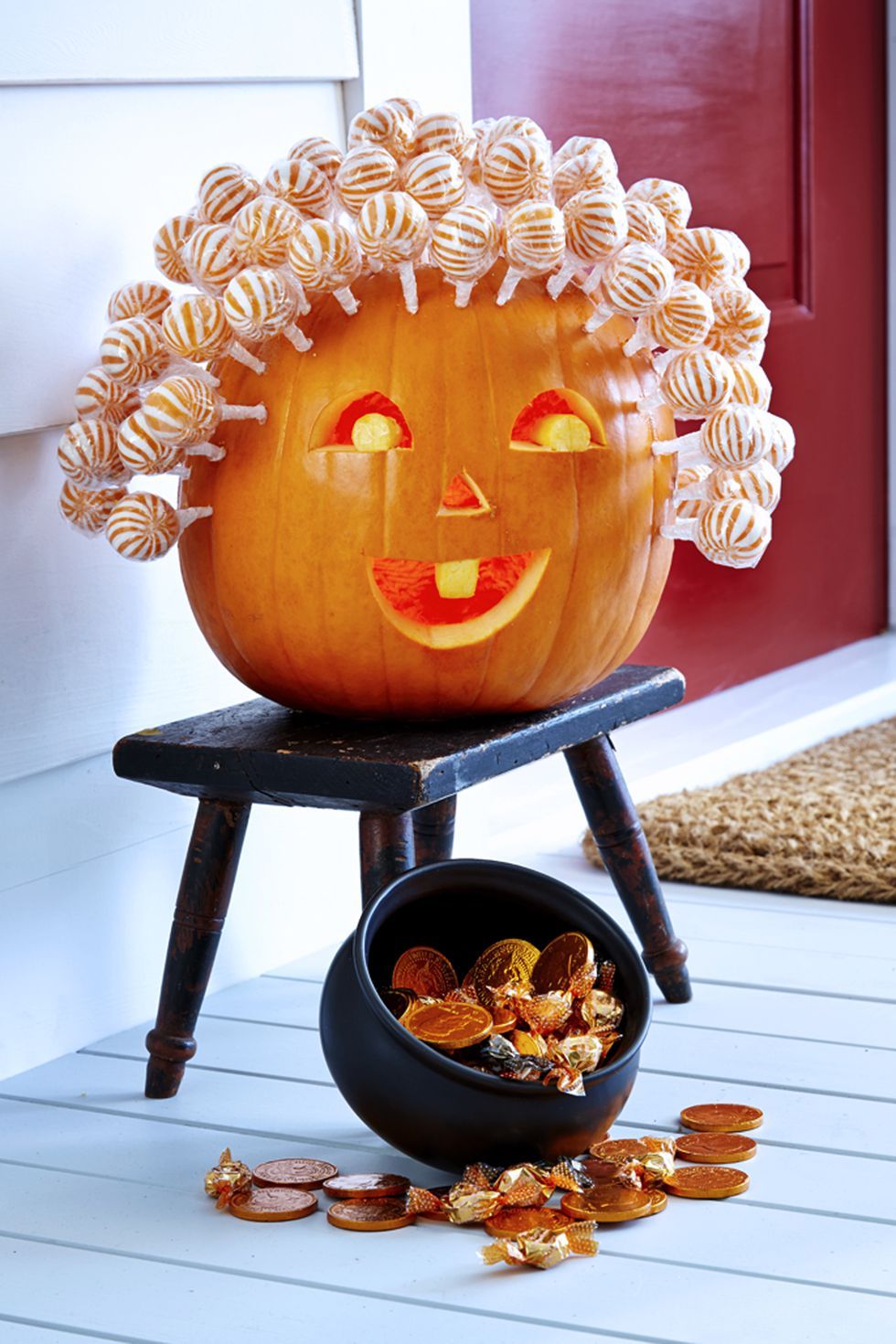 pumpkin faces, pumpkin with a carved face and lollipops for hair