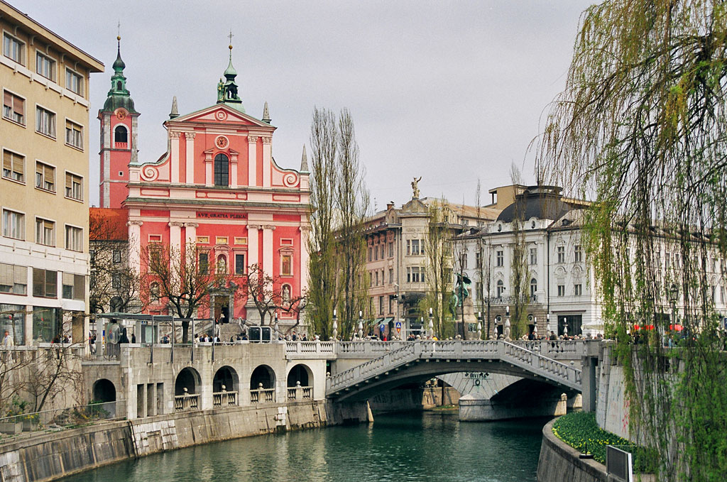 A bridge in Slovenia with buildings around.