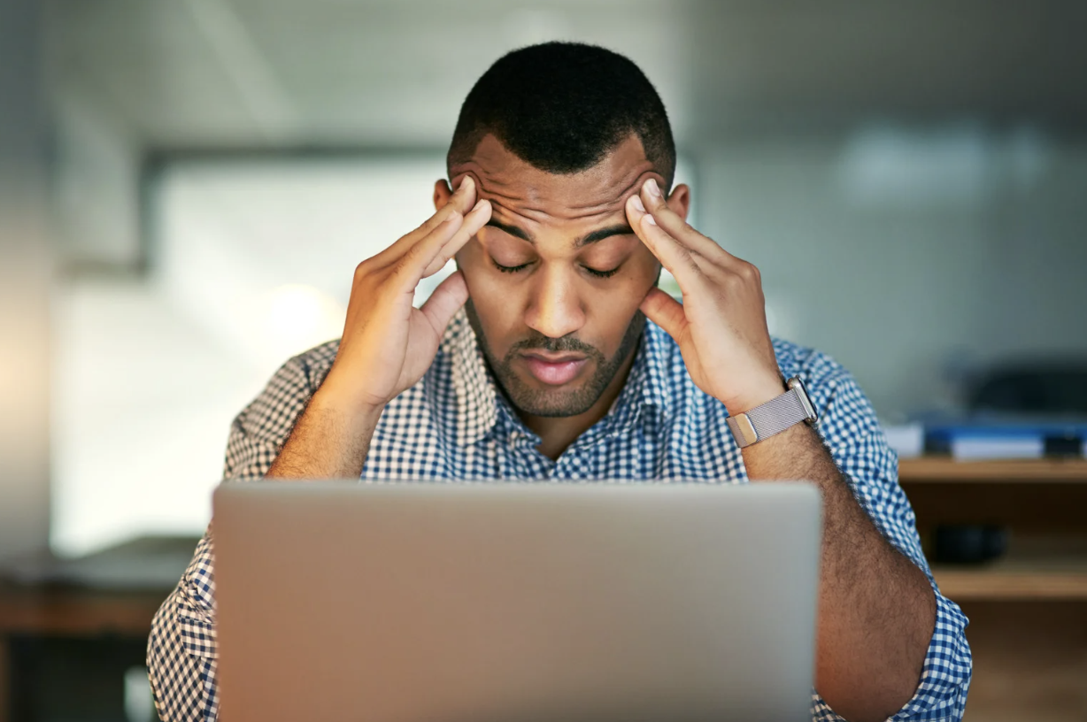 A person who is stressed in front of a computer