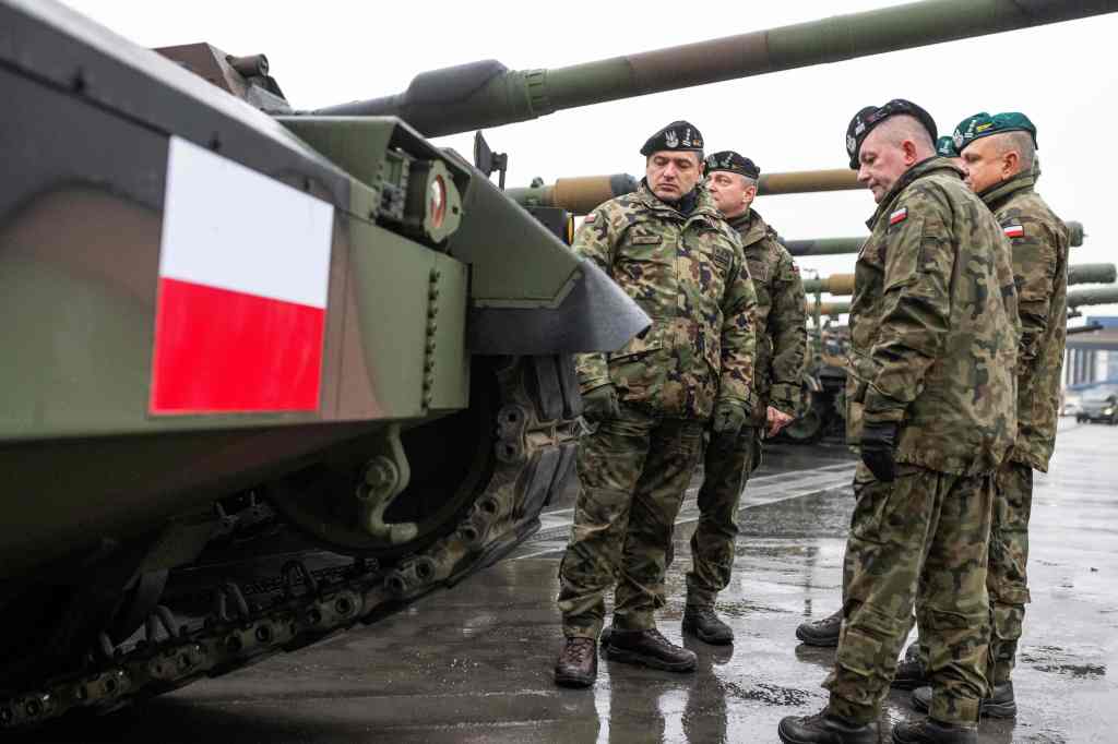 Polish Army soldiers stand next to tanks in the port after the arrival of the first K2 tanks and K9 howitzers for Poland on December 6, 2022 at the Baltic Container Terminal in Gdynia. - The Polish Army is strengthening its potential with the use of South Korean defense technologies. In July 2022 an agreement was concluded with Hyundai Rotem for the acquisition of a total of 1,000 K2 tanks with accompanying vehicles. Poland has massively stepped up weapons purchases since Russia invaded Ukraine, as well as sending military aid to Kyiv and taking in millions of Ukrainian refugees. (Photo by MATEUSZ SLODKOWSKI / AFP) (Photo by MATEUSZ SLODKOWSKI/AFP via Getty Images)