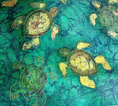A group of turtles on a fabric surface

Description automatically generated