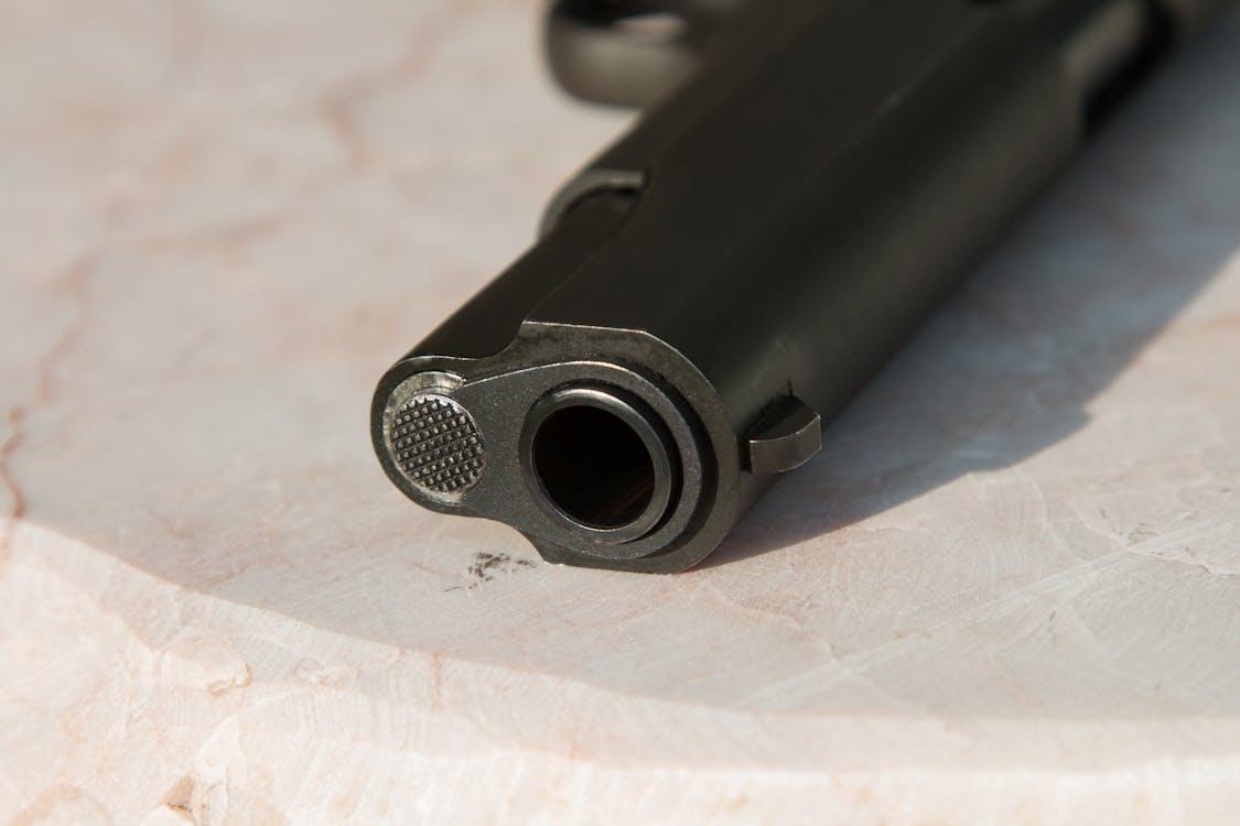 Free Black Metal Gun on White Surface Stock Photo