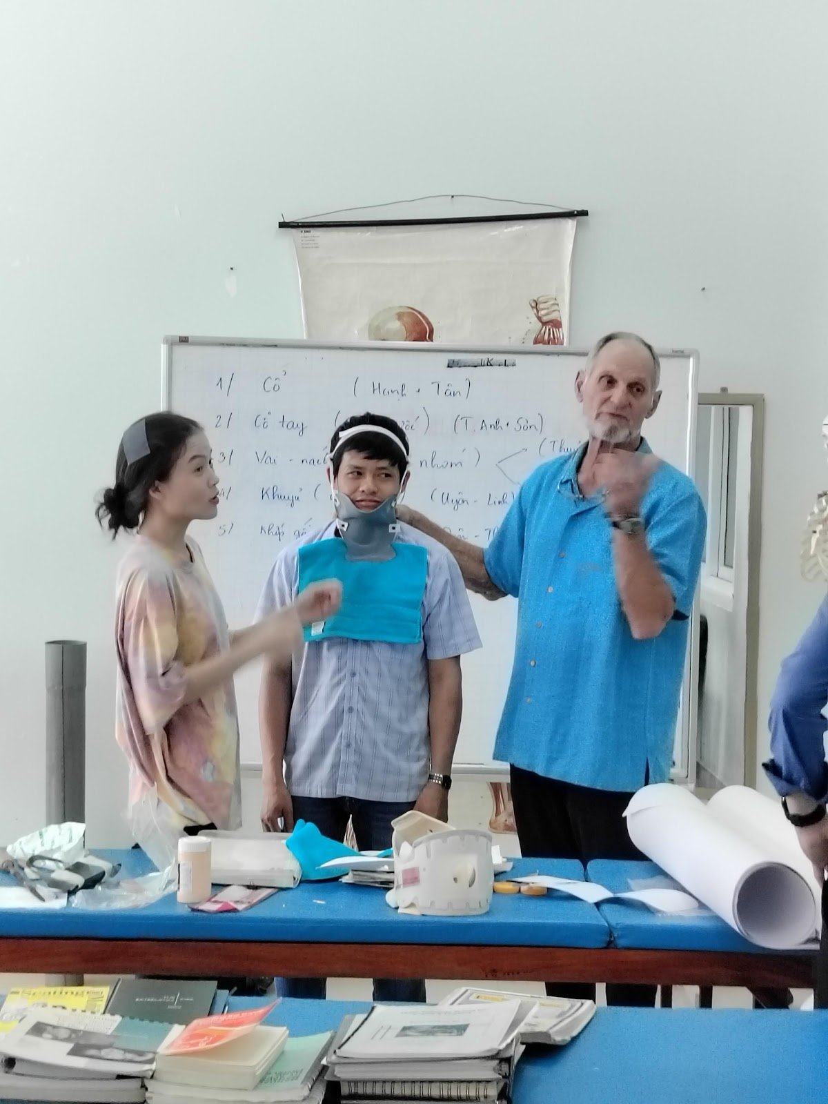 A group of people standing around a table

Description automatically generated
