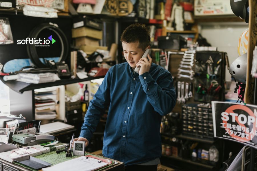 Man in workshop talking on the phone.