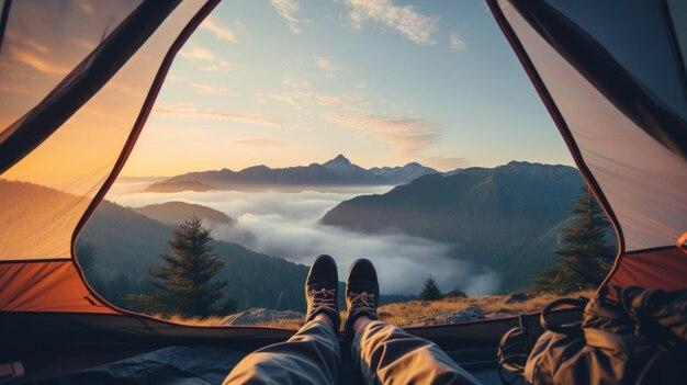 Camper enjoys the mountain view from the comfort of a tent with hiking boots pointing toward the horizon
