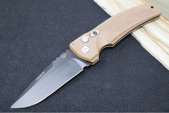 An image of the Hogue EX-A03 switchblade with a matte polymer handle on a simple black and wood background.