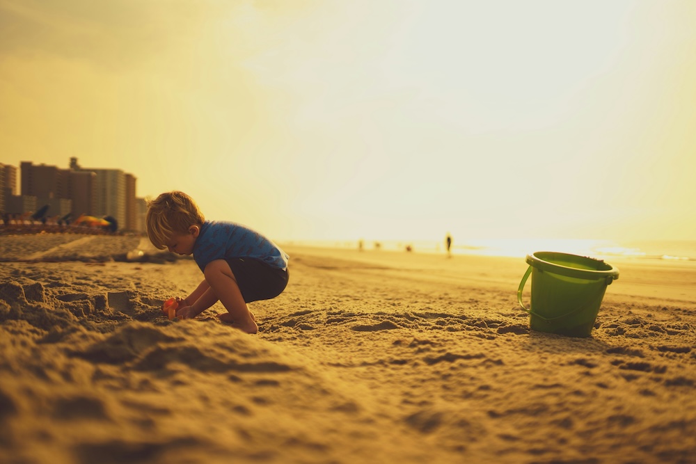 Child making sand castles at Surfside beach