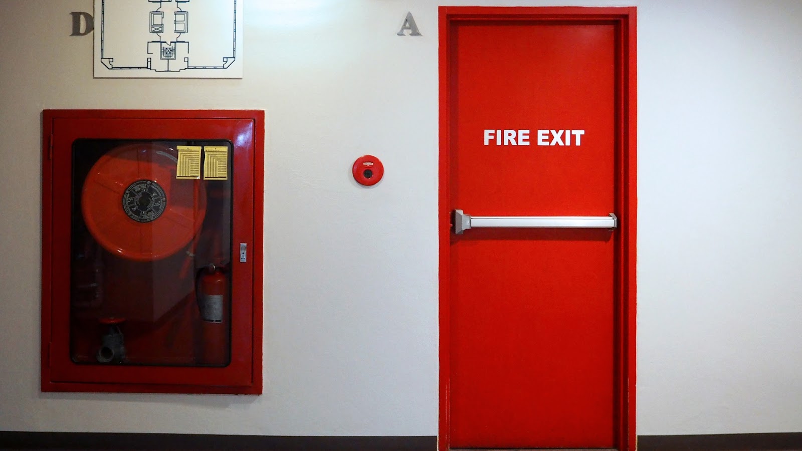 A panic bar in an exit door of a mall allows for quick evacuation during emergencies.