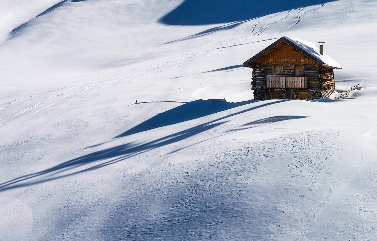 a house on a snowy mountain slope