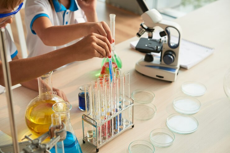 Engaging in hands-on STEM activities by filling test tubes in a science lab.