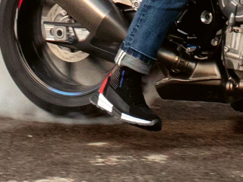 a motorcyclist wearing BMW KnitRace sneakers