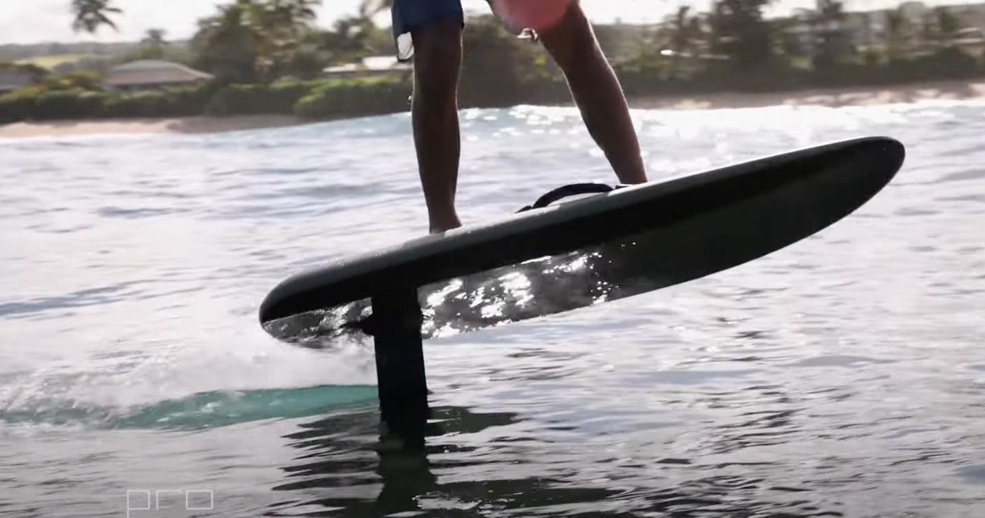 A person on a surfboard in the water

Description automatically generated