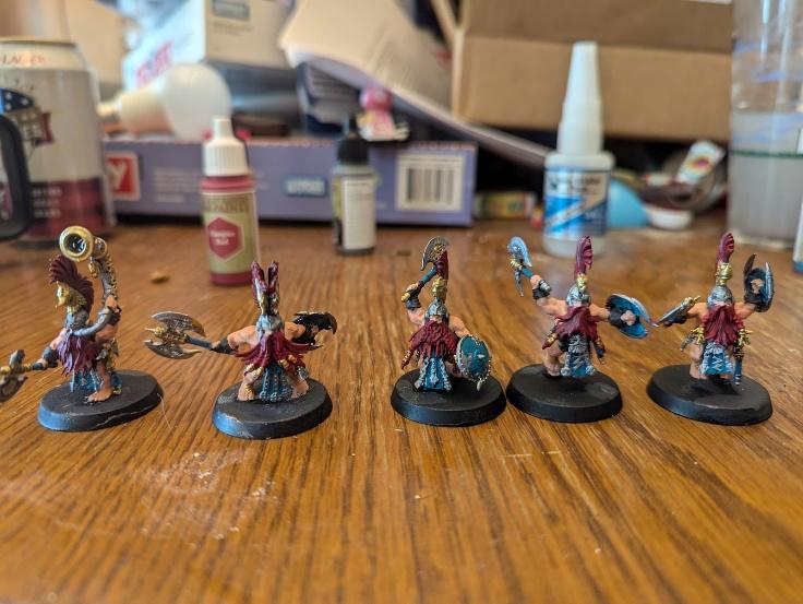 A group of miniature figures on a table Description automatically generated