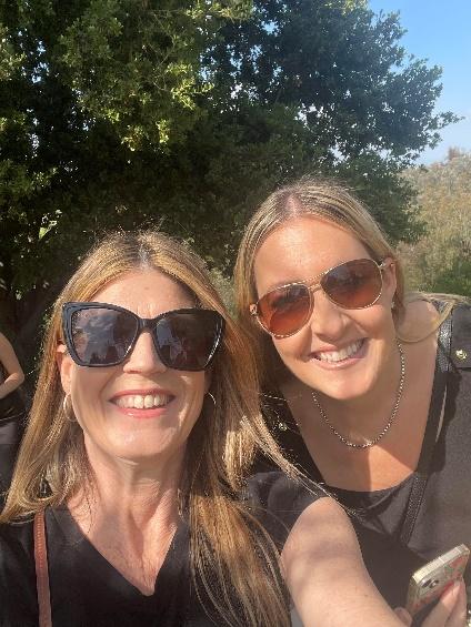 Two women taking a selfieDescription automatically generated