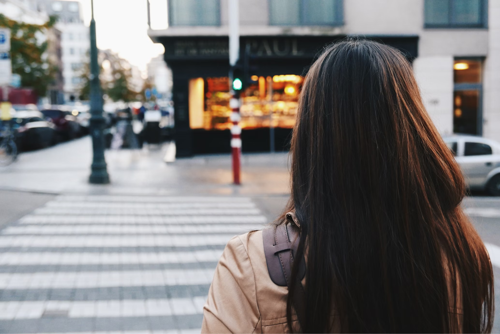 a woman standing on a sidewalk