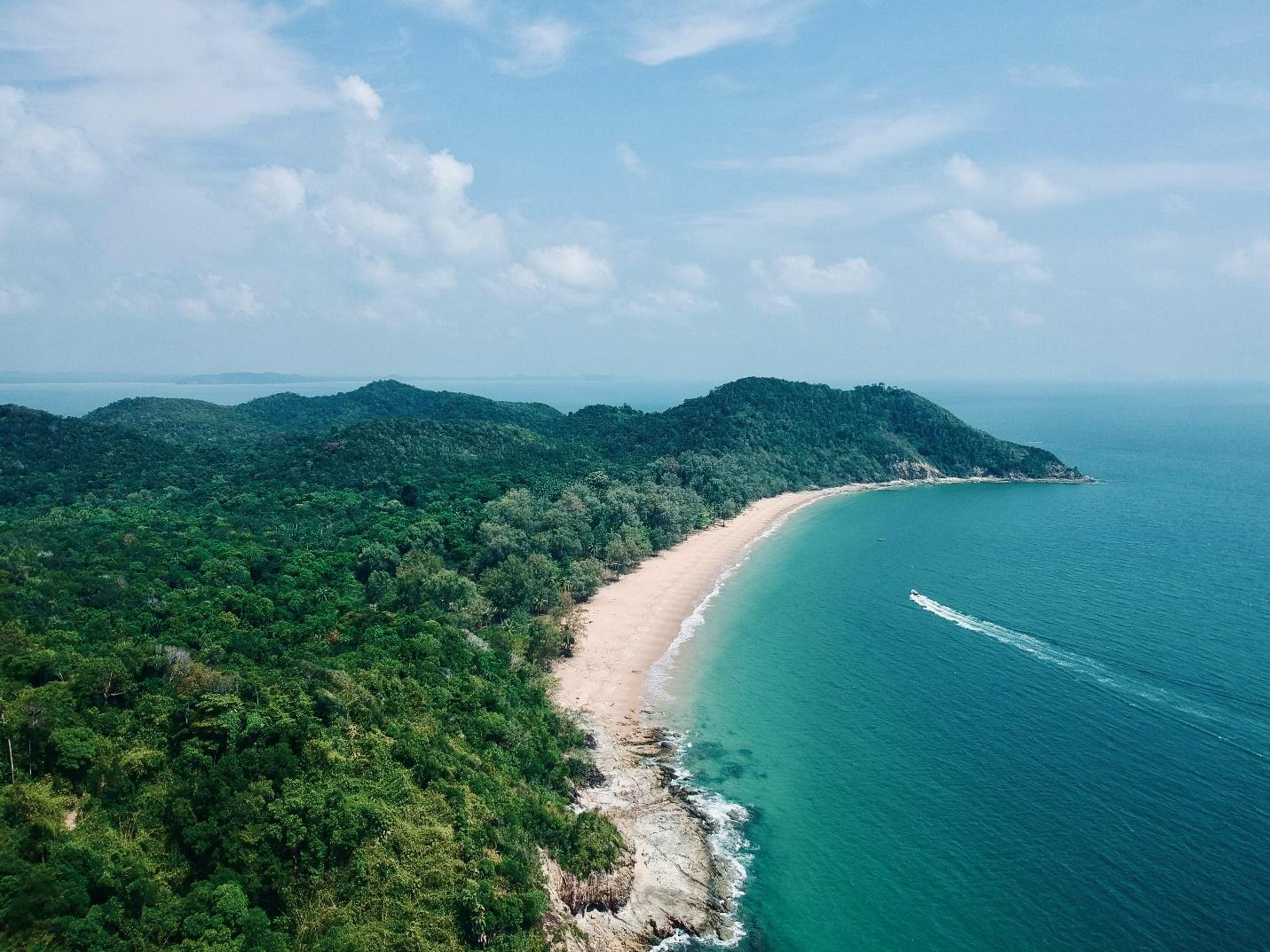 A boat cruising towards the Malaysian coastline